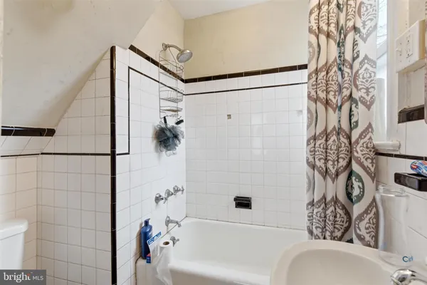 a bathroom with a bathtub and shower