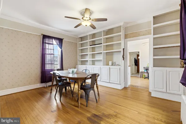 a view of a dining room with furniture and chandelier