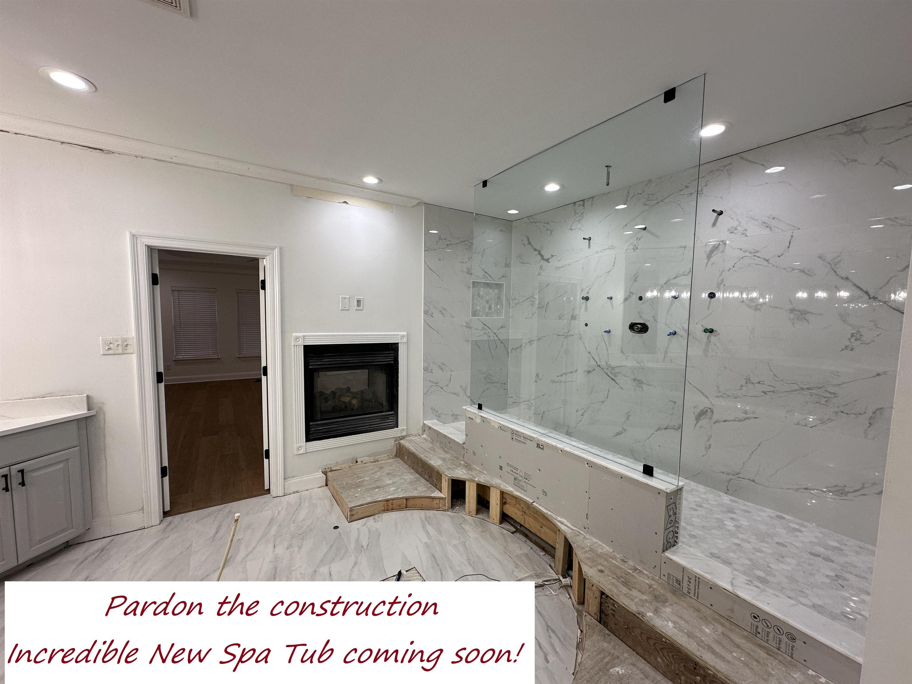 55 Hickory Nut Road Piperton, TN 38017 - Photo 12 of 40 Bathroom featuring marble finish floor, a glass covered fireplace, recessed lighting, a marble finish shower, and vanity