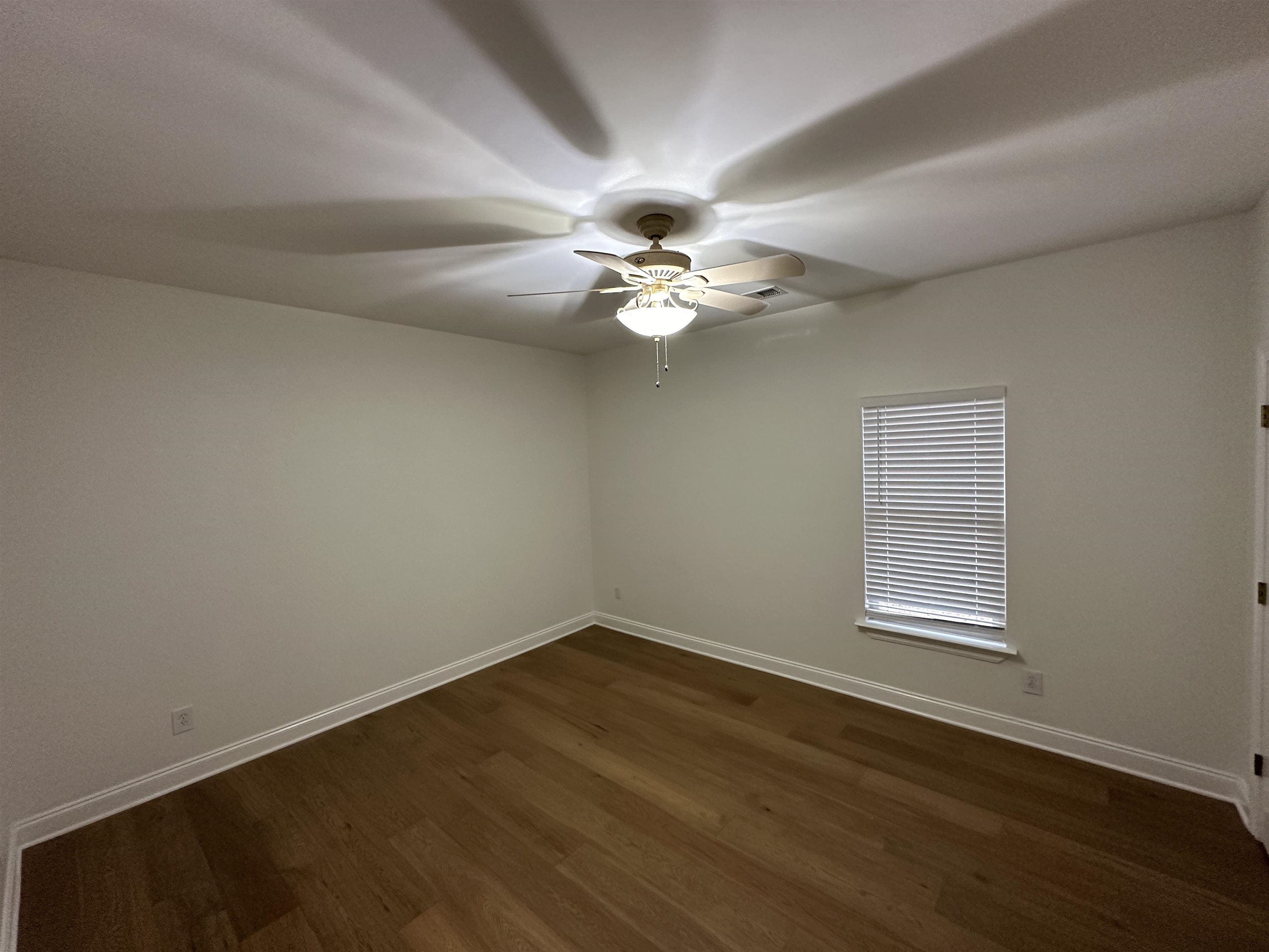 55 Hickory Nut Road Piperton, TN 38017 - Photo 19 of 40 Spare room featuring ceiling fan, baseboards, and dark wood-style floors