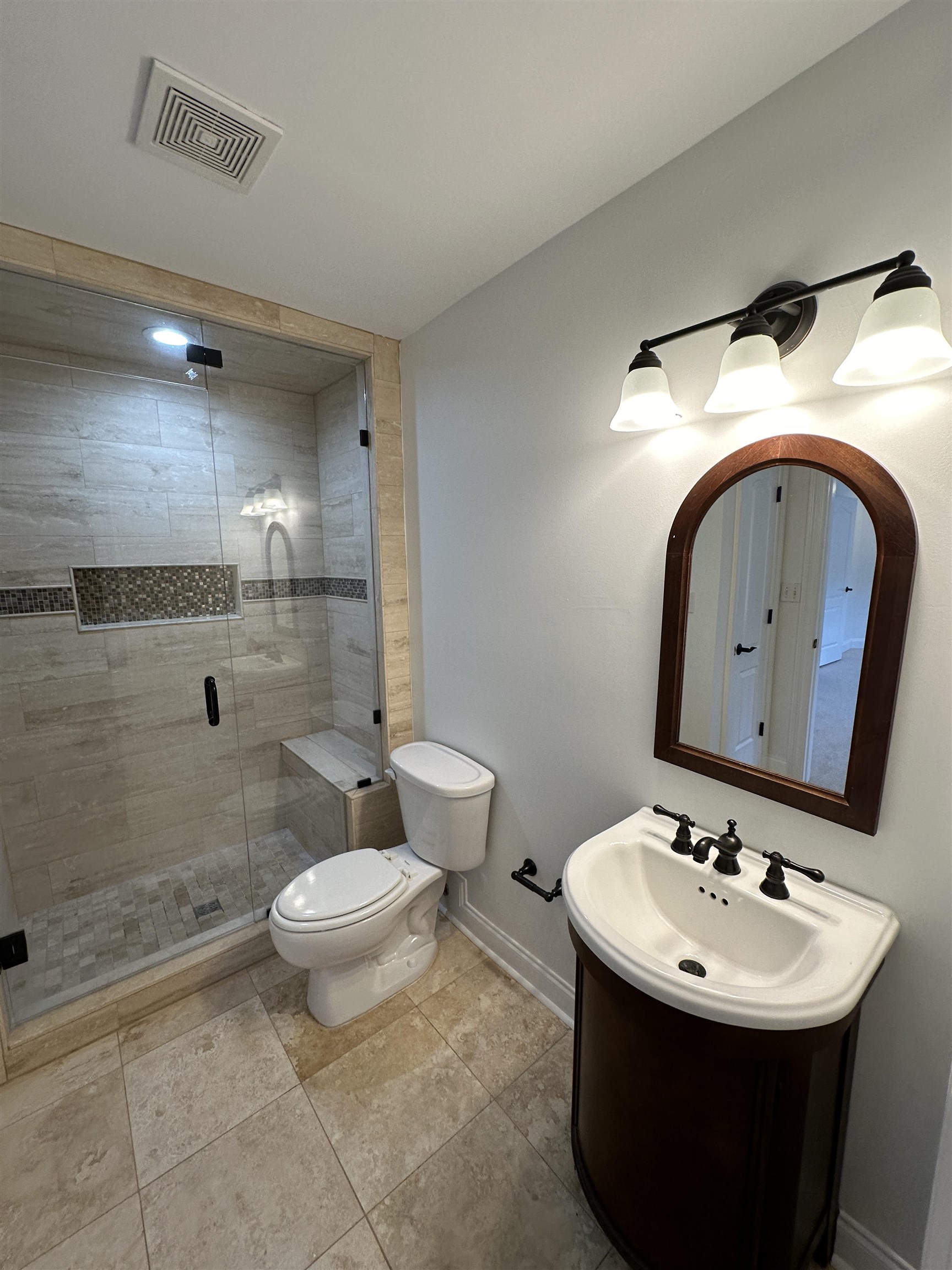 55 Hickory Nut Road Piperton, TN 38017 - Photo 20 of 40 Full bathroom with visible vents, baseboards, toilet, a stall shower, and vanity