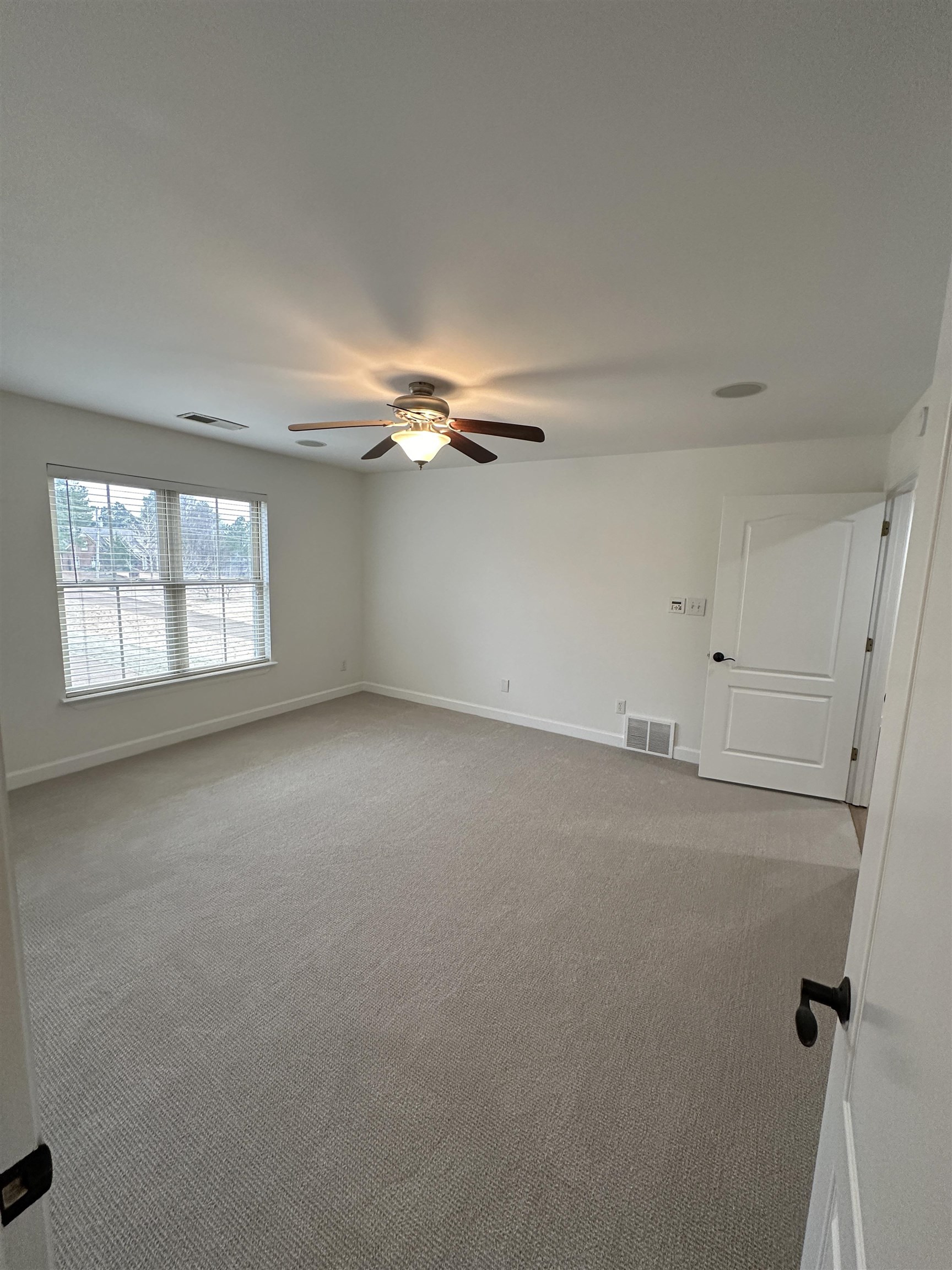 55 Hickory Nut Road Piperton, TN 38017 - Photo 21 of 40 Carpeted empty room with visible vents, ceiling fan, and baseboards