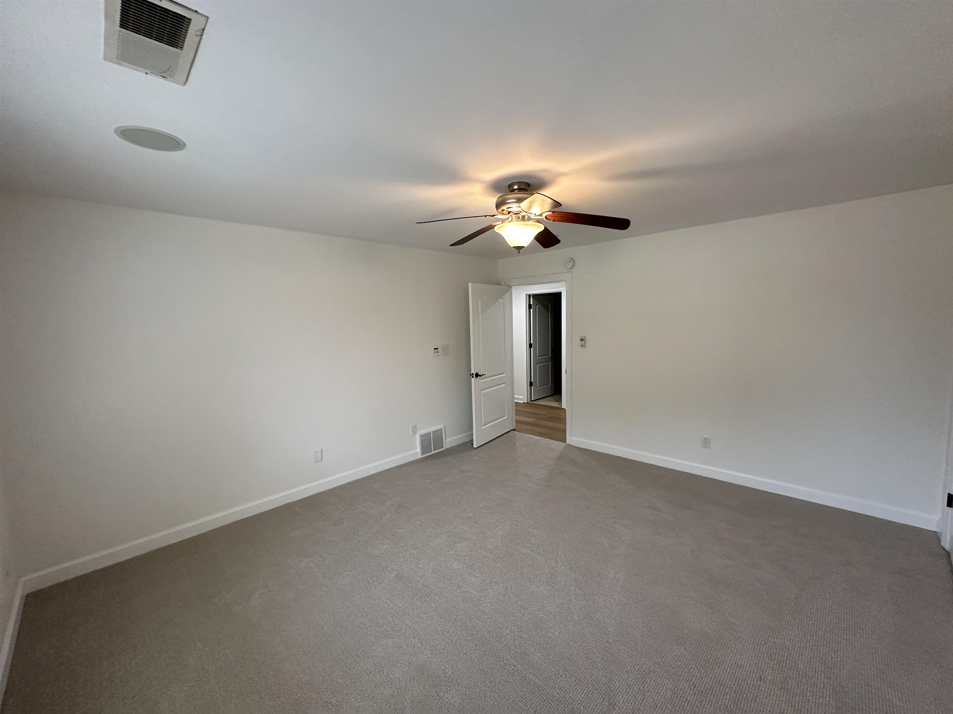 55 Hickory Nut Road Piperton, TN 38017 - Photo 22 of 40 Empty room featuring visible vents, baseboards, a ceiling fan, and dark carpet