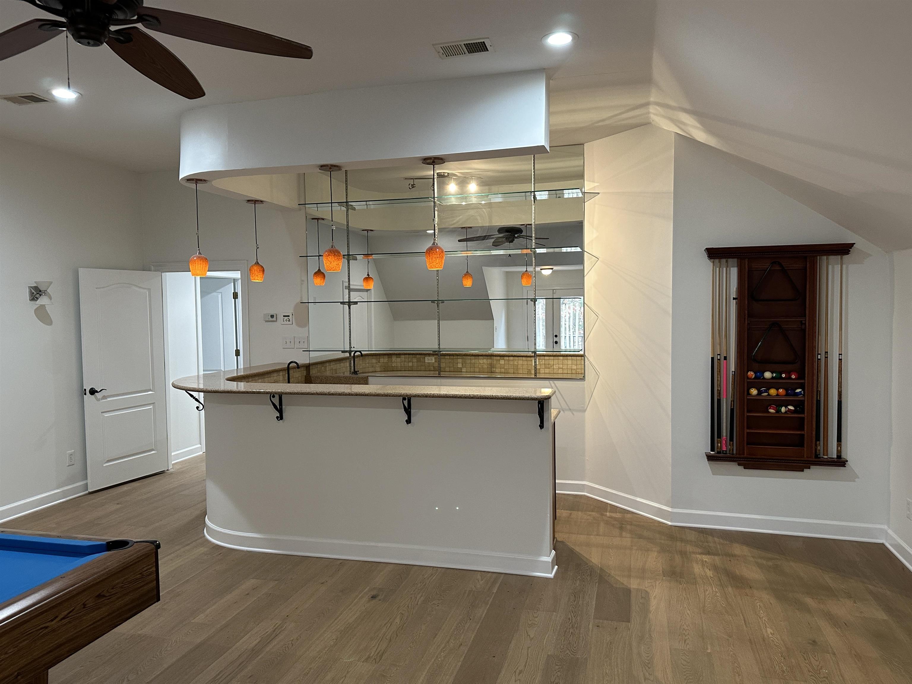 55 Hickory Nut Road Piperton, TN 38017 - Photo 27 of 40 Kitchen featuring a kitchen island with sink, visible vents, a kitchen breakfast bar, and dark wood-style floors