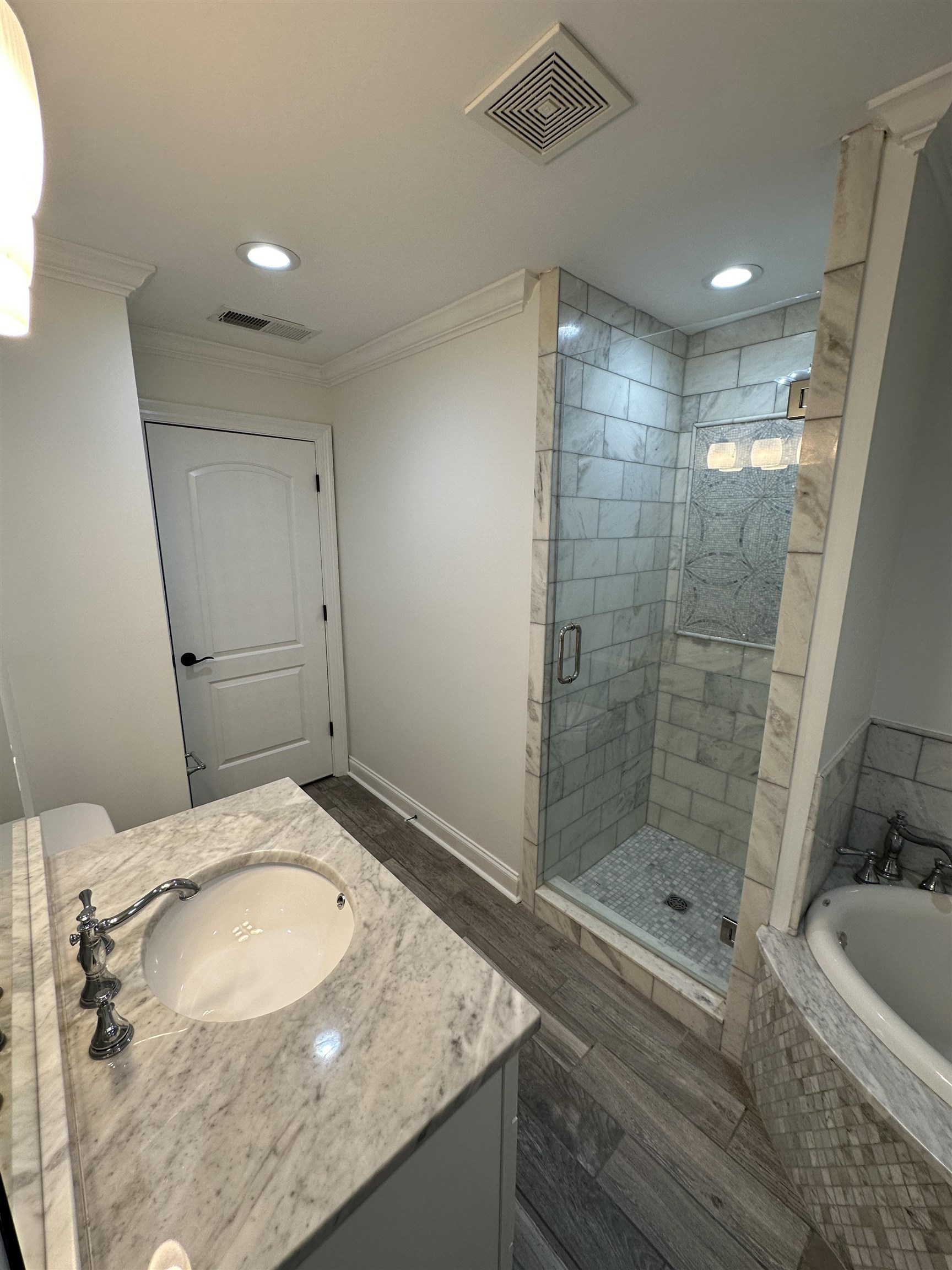 55 Hickory Nut Road Piperton, TN 38017 - Photo 29 of 40 Bathroom featuring a bath, visible vents, a shower stall, and crown molding