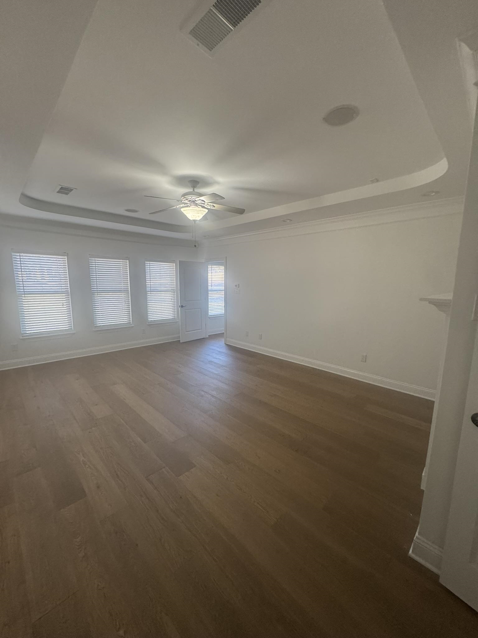 55 Hickory Nut Road Piperton, TN 38017 - Photo 8 of 40 Empty room with visible vents, a raised ceiling, baseboards, and dark wood finished floors