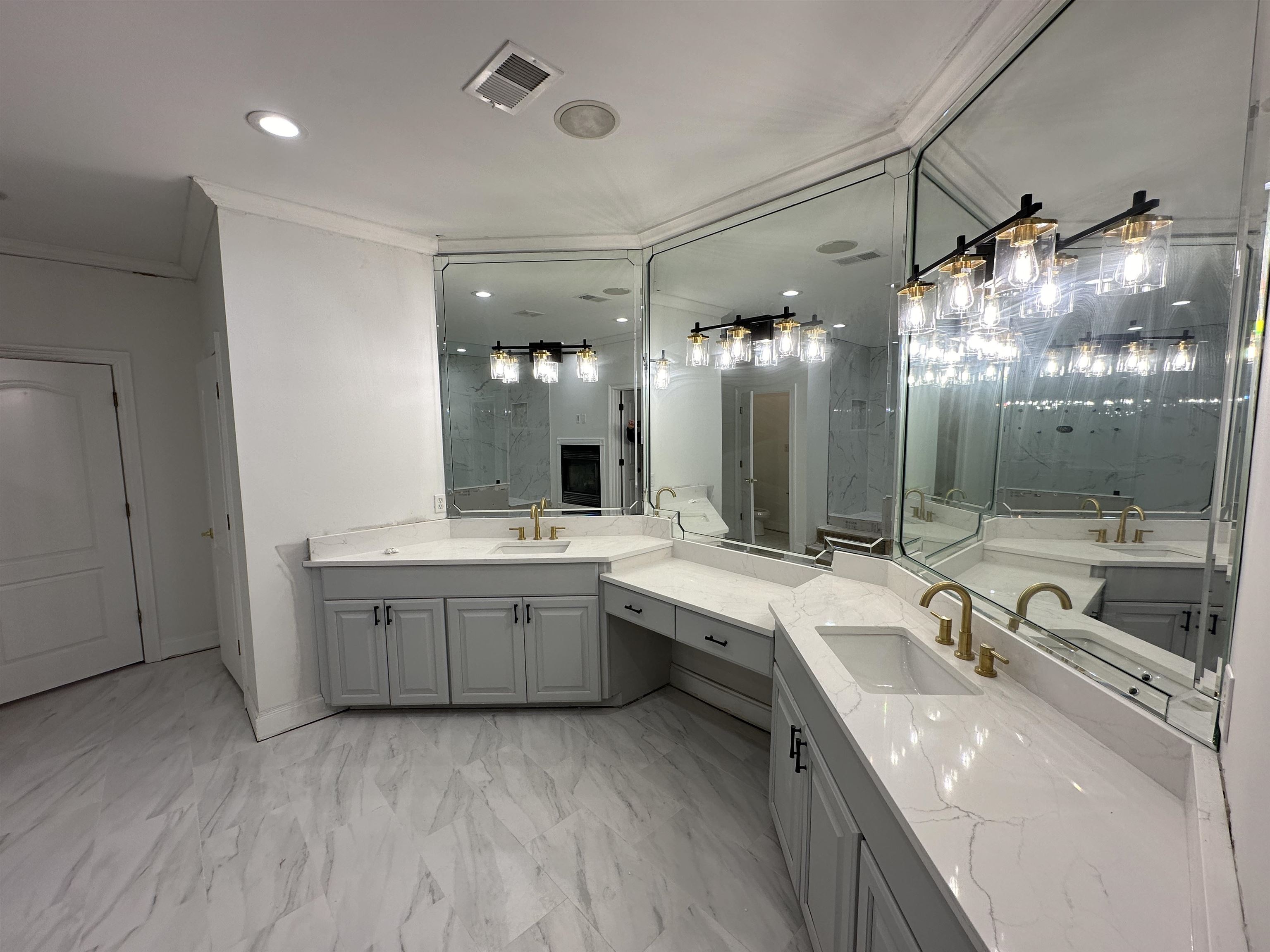 55 Hickory Nut Road Piperton, TN 38017 - Photo 10 of 40 Bathroom with visible vents, crown molding, two vanities, and a sink