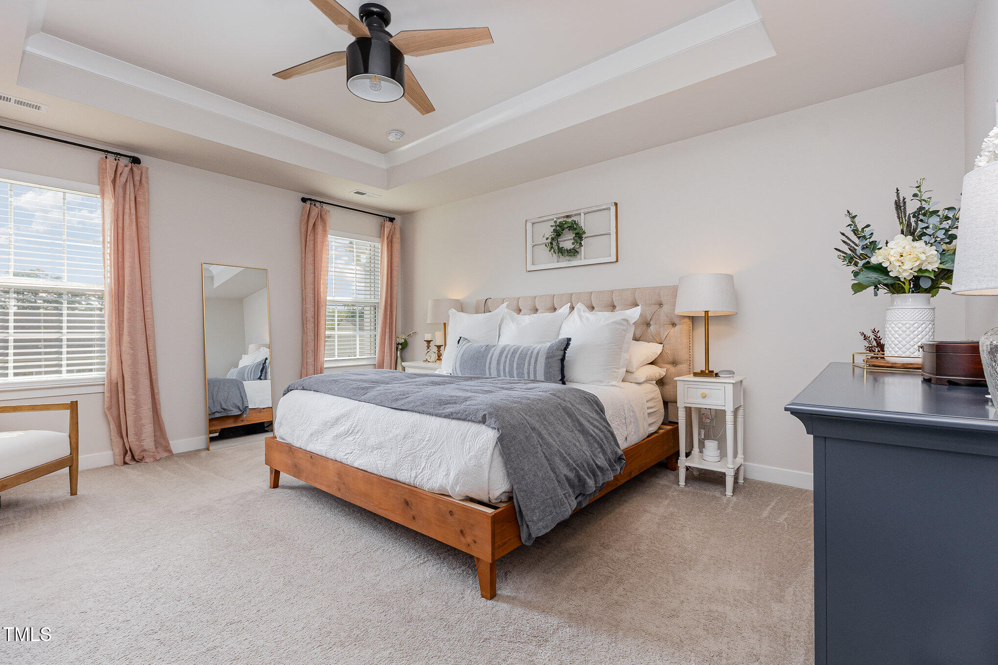 235 Misty Pike Drive Raleigh, NC 27603 - Photo 15 of 29 a spacious bedroom with a bed and a chandelier