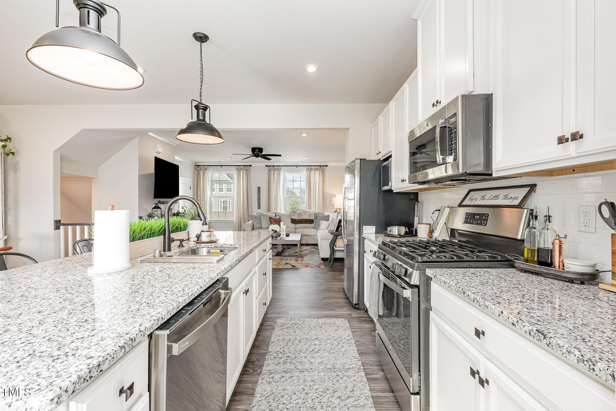 235 Misty Pike Drive Raleigh, NC 27603 - Photo 6 of 29 a kitchen with stainless steel appliances granite countertop a sink stove and cabinets