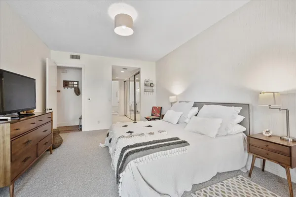 a bedroom with a bed and a flat screen tv