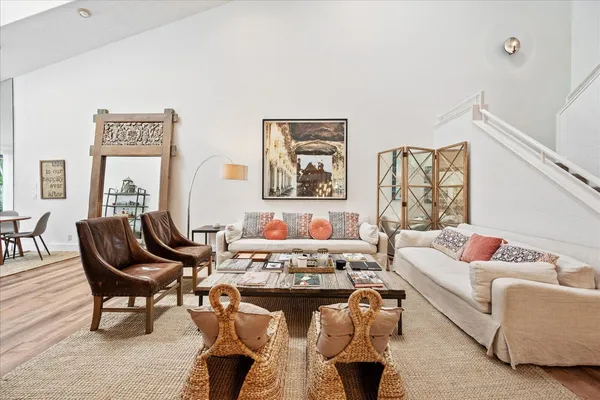 a living room with furniture and a potted plant