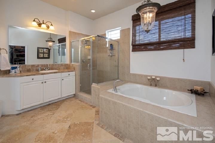 10575 Kenai Drive Reno, NV 89521 - Photo 30 of 40 a bathroom with a tub sink and mirror