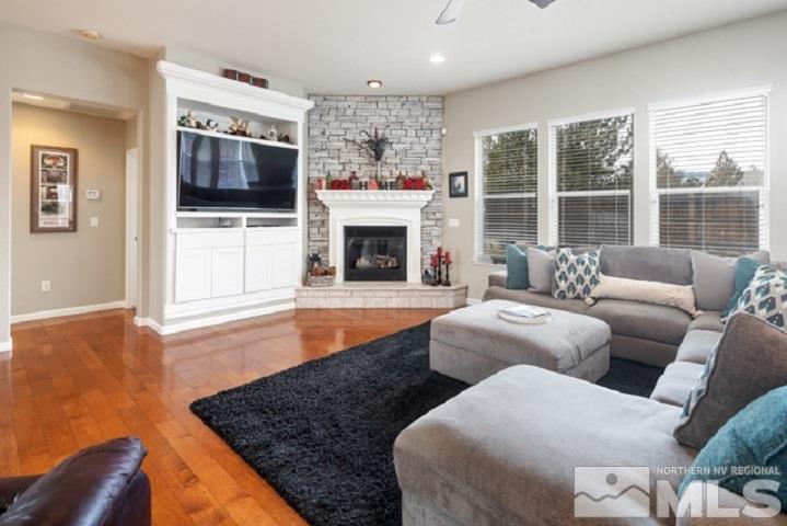 10575 Kenai Drive Reno, NV 89521 - Photo 8 of 40 a living room with furniture a flat screen tv and a fireplace