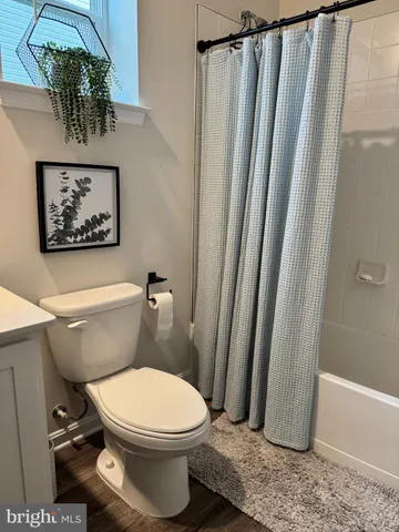 a bathroom with a toilet a sink and a shower