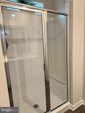 a bathroom with a glass shower door
