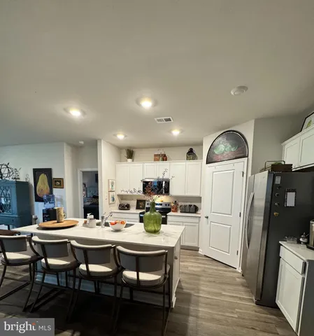a kitchen with a sink and chairs