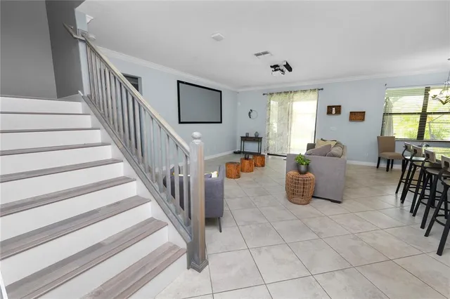 a living room with furniture and a wall painting
