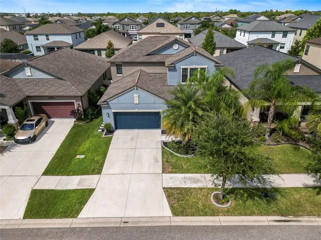 an aerial view of a house with a yard