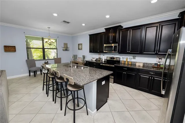 a kitchen with granite countertop stainless steel appliances lots of counter top space