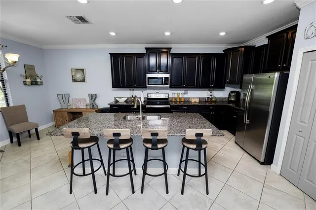 a dining room with furniture and a chandelier