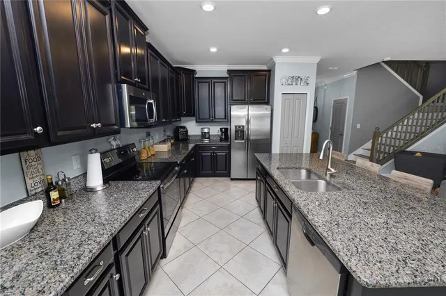 a living room with furniture and kitchen view