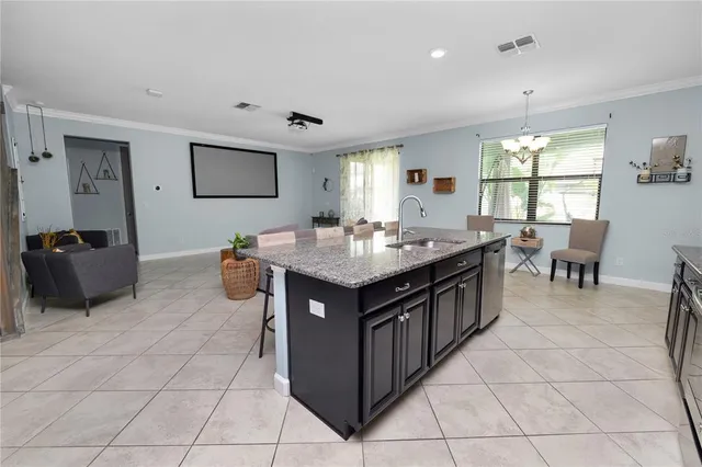 a living room with furniture and kitchen view