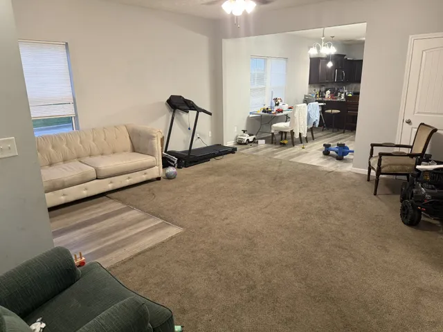 a living room with furniture and a mirror