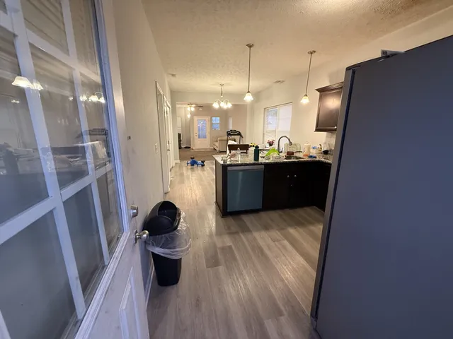a living room with furniture and a chandelier
