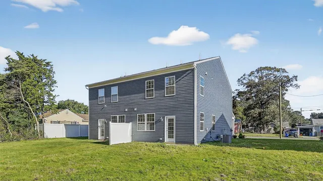 a house view with a sitting space and garden