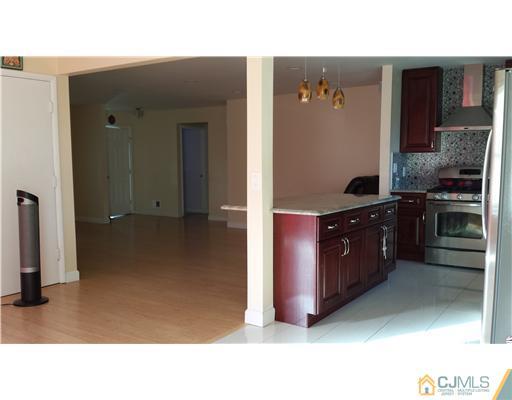 33 Woodbury Road Edison, NJ 08820 - Photo 3 of 11 a kitchen with stainless steel appliances granite countertop a stove and a refrigerator