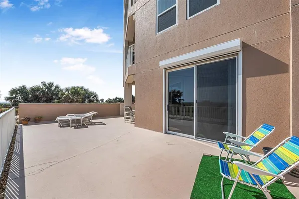 a view of a terrace with couches and sky view