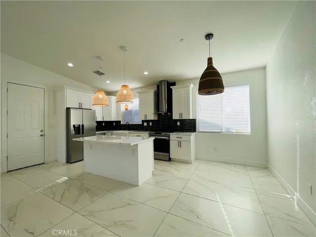 a kitchen with granite countertop a sink a stove and cabinets