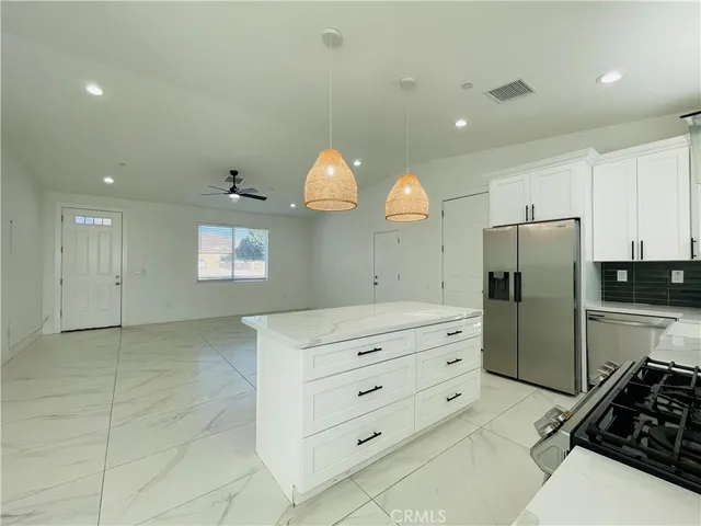 a kitchen with a refrigerator and a sink