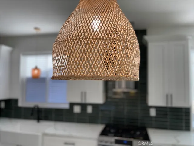 a kitchen with granite countertop a sink a stove and cabinets