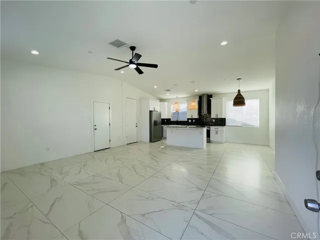 a view of a kitchen with a sink and a stove top oven