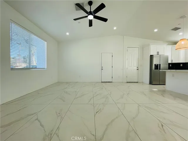 a view of a kitchen with a sink and a refrigerator