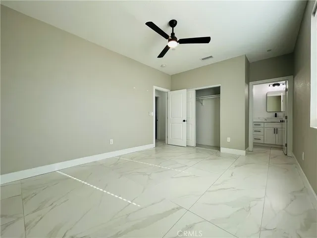 a bathroom with a toilet sink double vanity and mirror