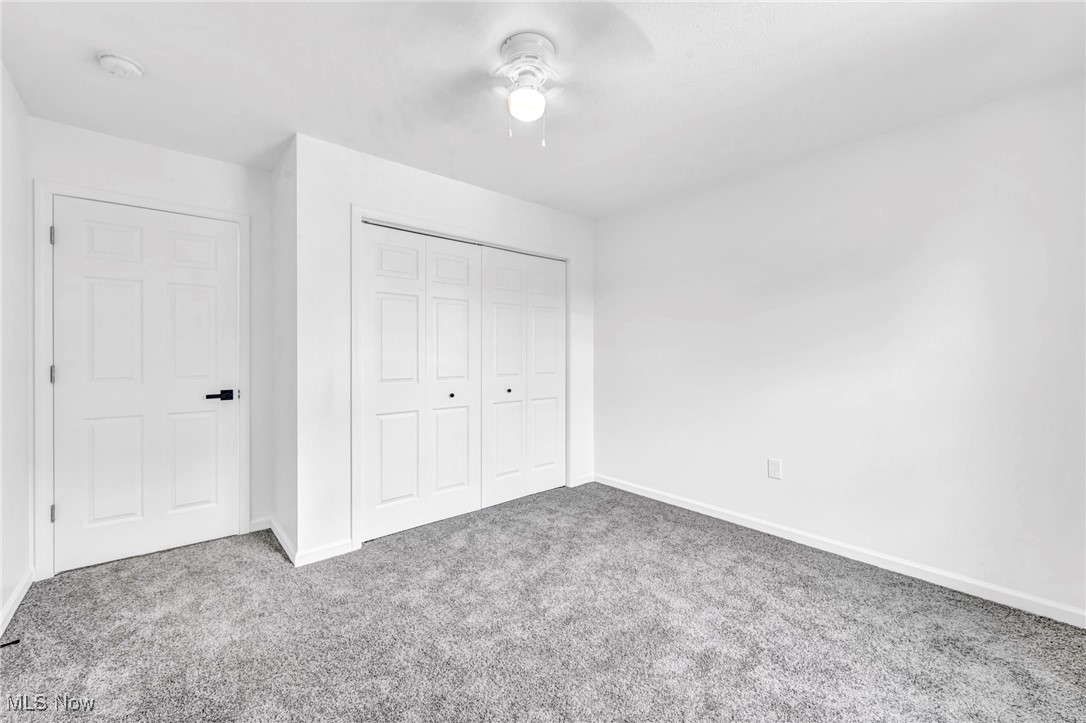 3709 Sudbury Road Cleveland, OH 44120 - Photo 19 of 29 Unfurnished bedroom with a closet, ceiling fan, and carpet flooring