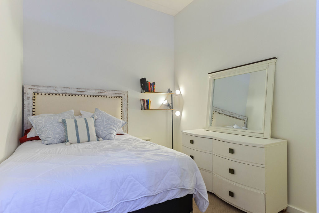 1224 West Van Buren Street, Unit 707 Chicago, IL 60607 - Photo 11 of 15 a bedroom with a bed and a window