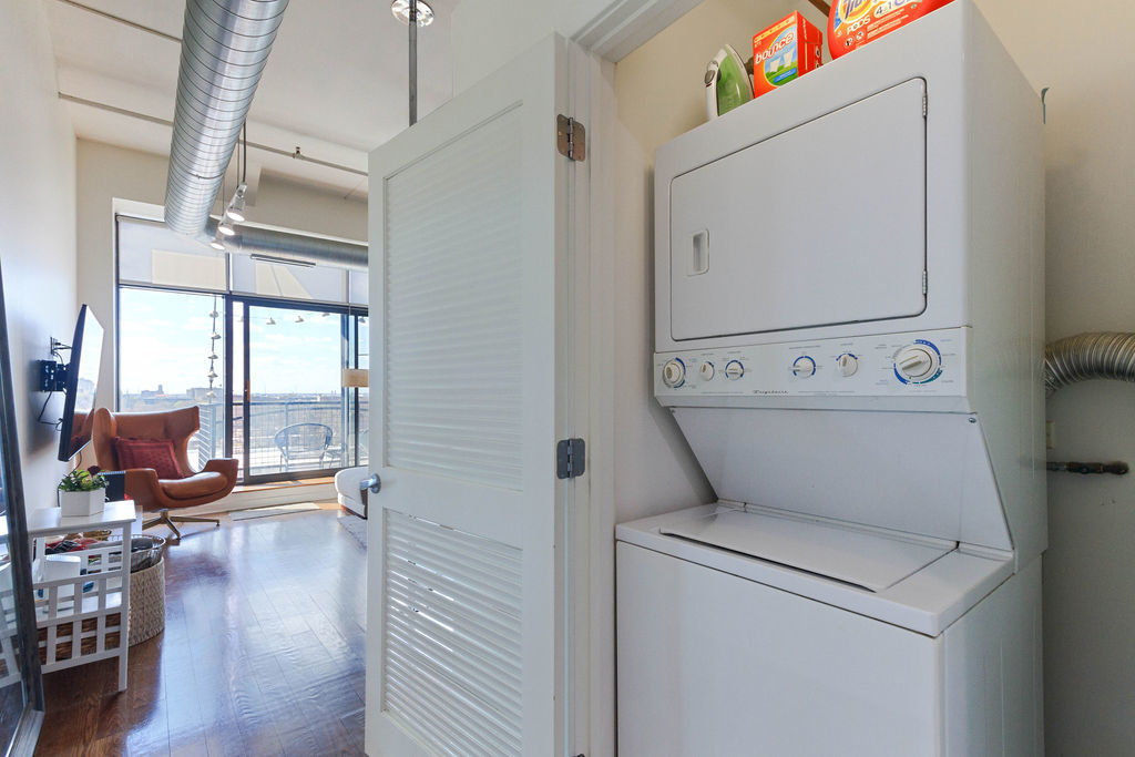 1224 West Van Buren Street, Unit 707 Chicago, IL 60607 - Photo 13 of 15 a view of washer and dryer with wooden floor
