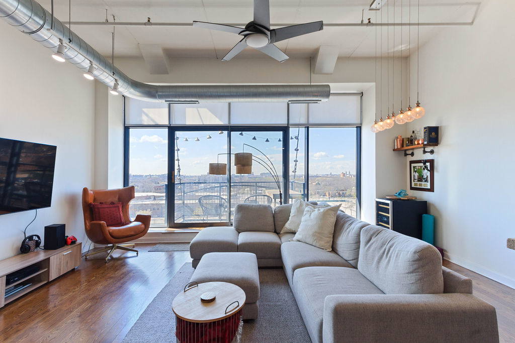 1224 West Van Buren Street, Unit 707 Chicago, IL 60607 - Photo 2 of 15 a living room with furniture and a large window