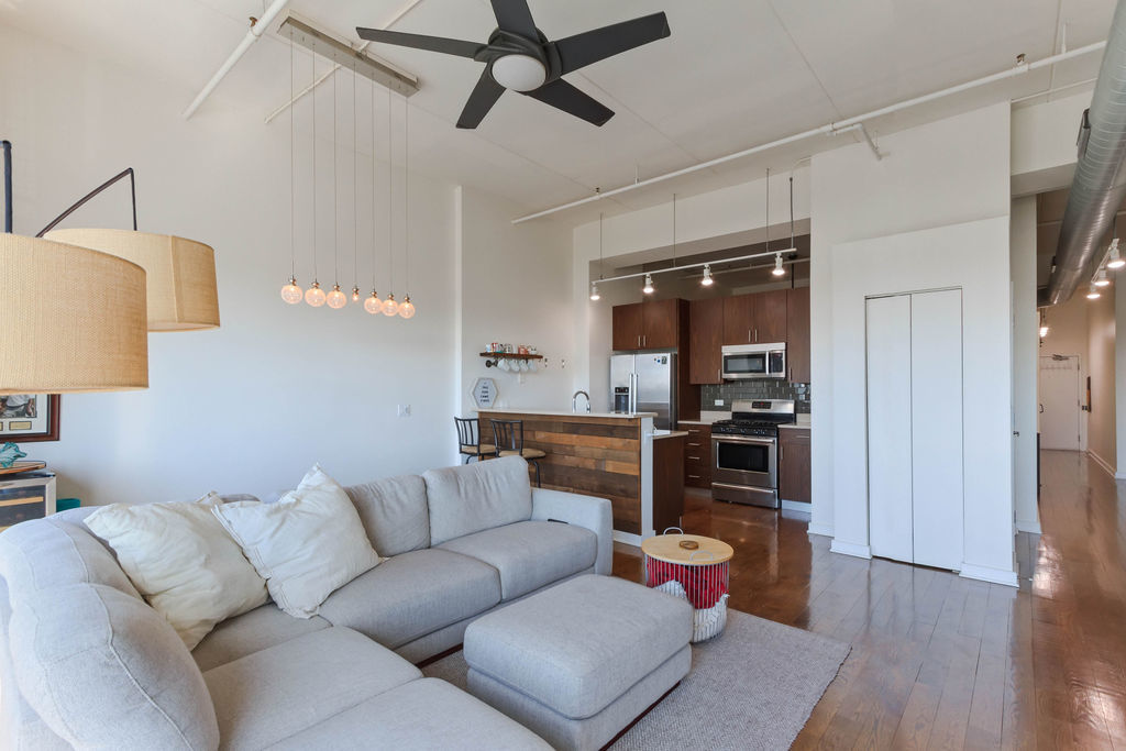 1224 West Van Buren Street, Unit 707 Chicago, IL 60607 - Photo 4 of 15 a living room with furniture and a wooden floor