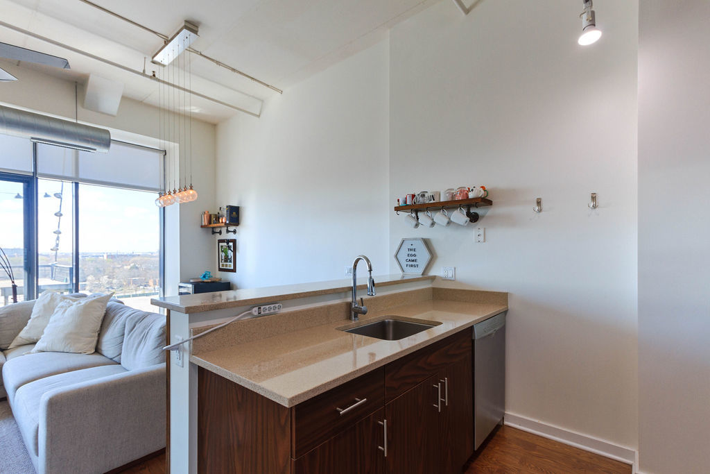 1224 West Van Buren Street, Unit 707 Chicago, IL 60607 - Photo 7 of 15 a kitchen with a sink and a window