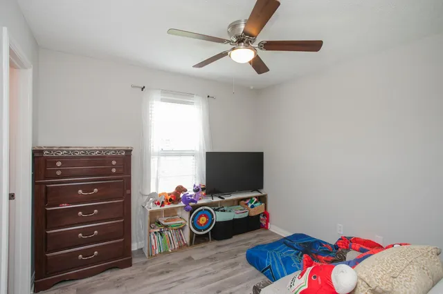 a bedroom with a bed window and a dresser