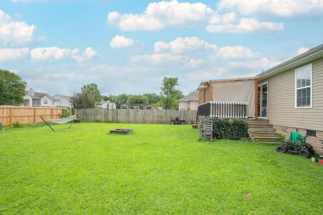 a view of a backyard with sitting area