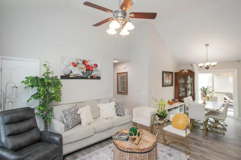 a living room with furniture and a chandelier