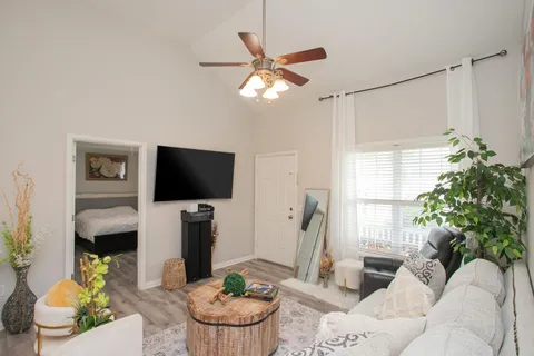 a living room with furniture and a flat screen tv