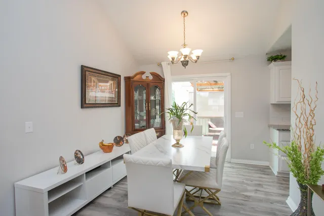 a view of a dining room with furniture wooden floor and chandelier