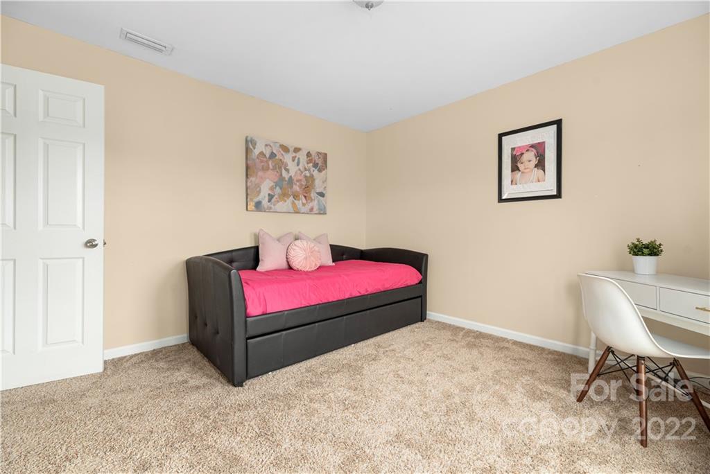 2219 Durand Road Fort Mill, SC 29715 - Photo 20 of 39 a bedroom with a bed and a chair in it