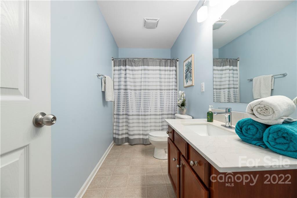 2219 Durand Road Fort Mill, SC 29715 - Photo 23 of 39 a spacious bathroom with a granite countertop sink a toilet and shower